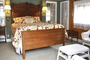 The Garden Gate room bed and the sitting area at Meadow Creek Ranch Inn in Mariposa California near Yosemite National Park